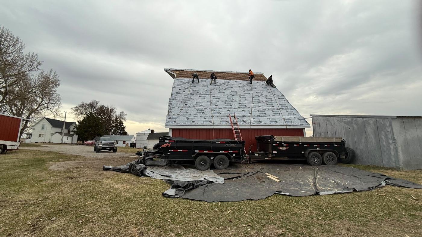 MGS Construction crew re-roofing a barn